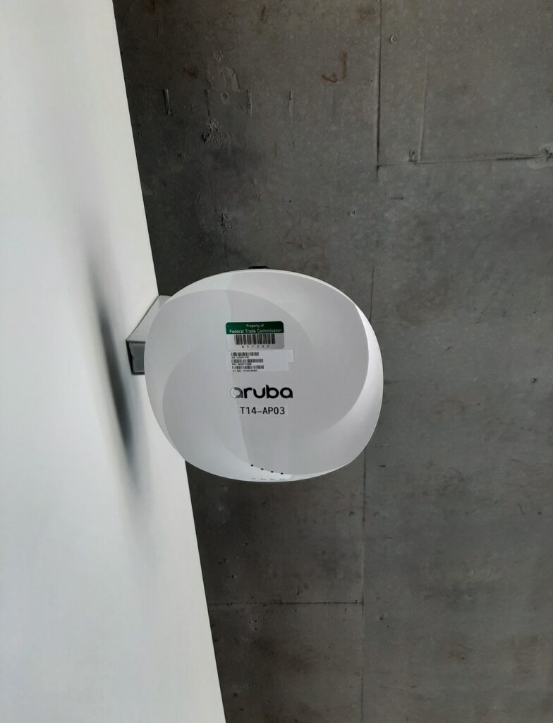 Aruba wireless access point installed on wall bracket