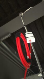 Network jack with red patch cable plugged in