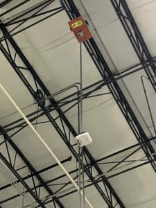 Wireless access point attached to extension pole in warehouse