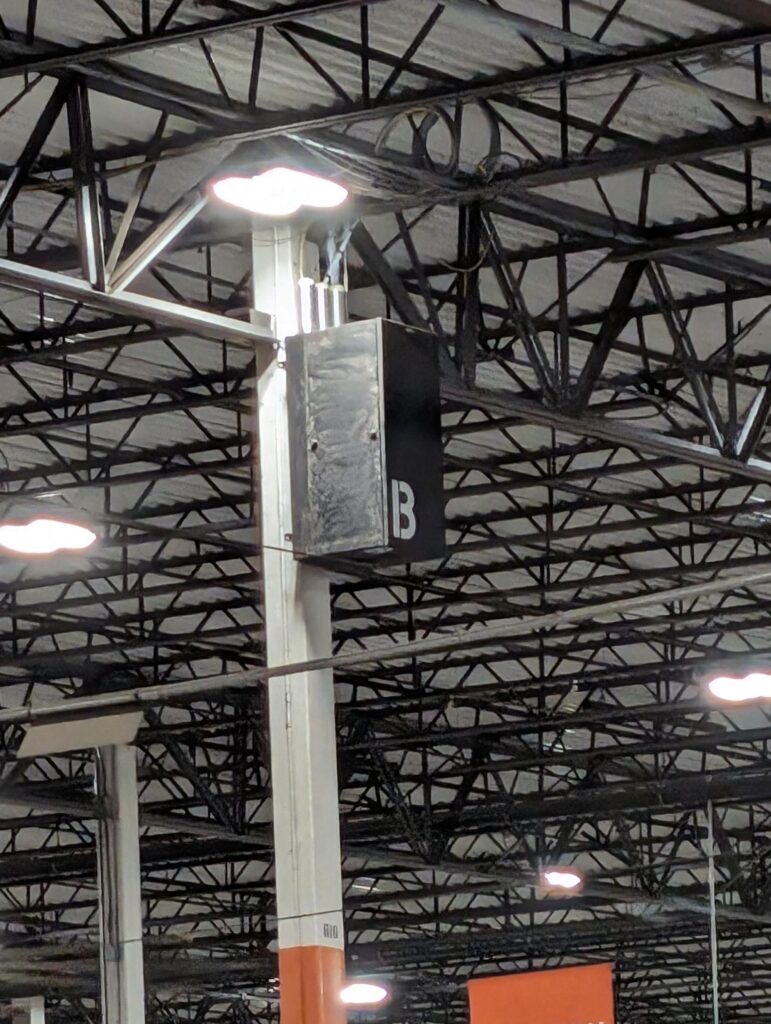 Network rack installed on pole in warehouse