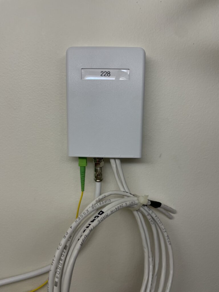 Cabling media center mounted on wall with cables connected